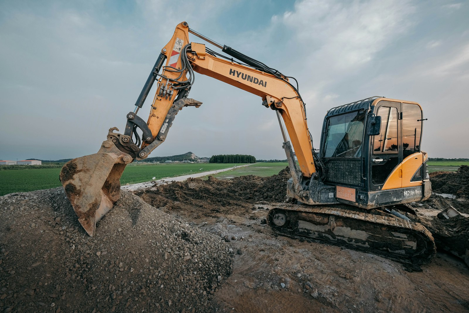 Excavator preparing earthwork on a construction site